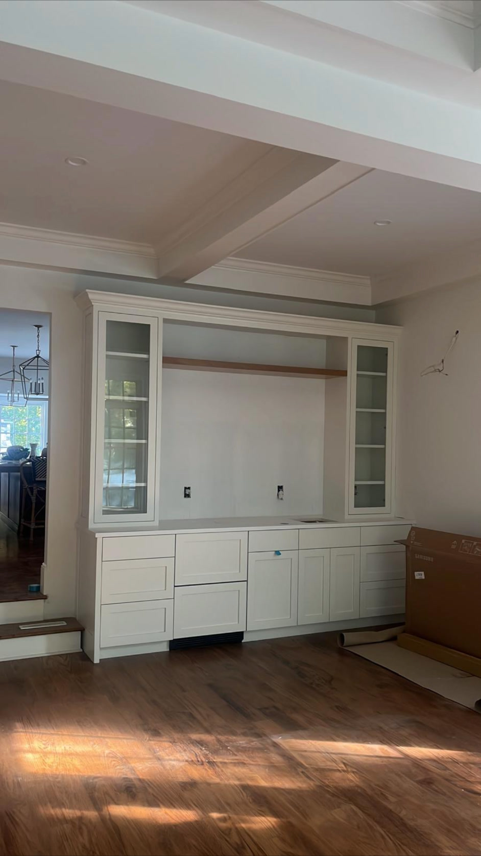 White built-in cabinetry with glass display cabinets and drawers